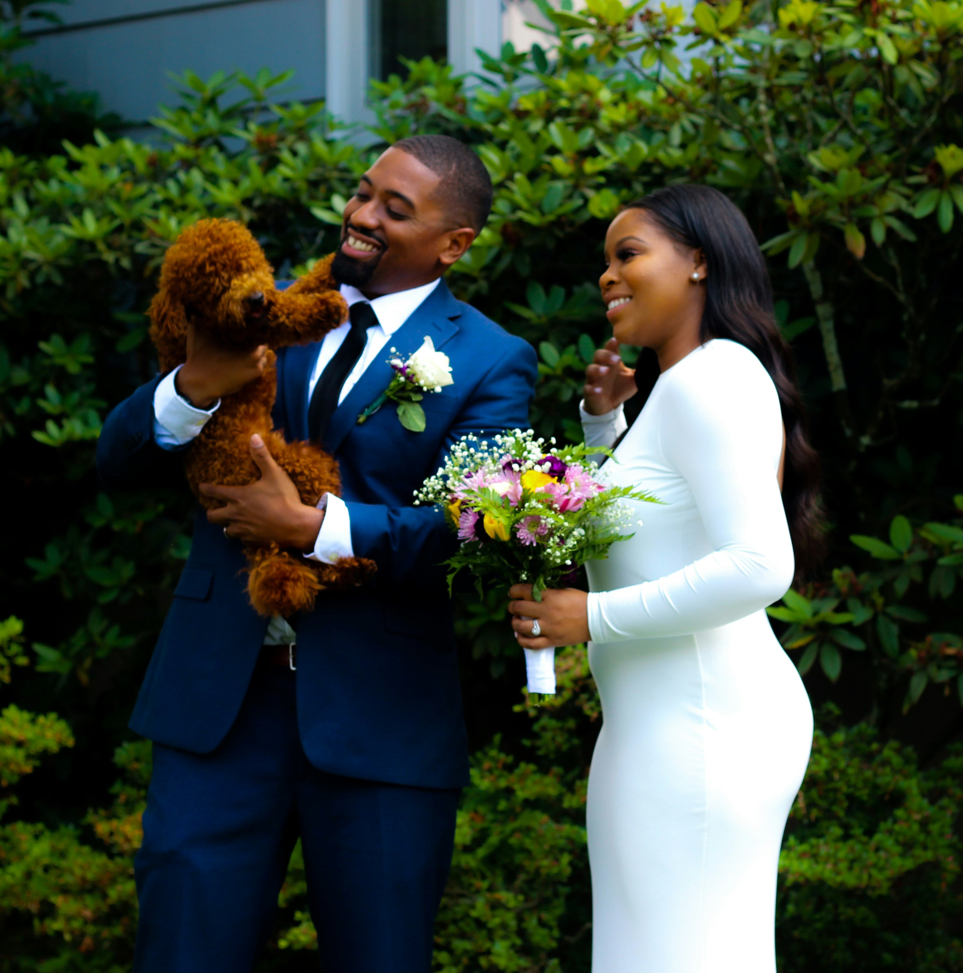 couple with dog on wedding day